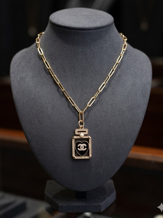 Chanel. Jewelry - ChaneI Gold Tone Perfume Bottle Pendant Necklace with Pearl on Black Heart
